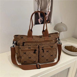 Brown corduroy tote bag with bow prints and multiple zipper pockets for daily use