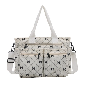 Grande borsa a tracolla in velluto beige con fiocchi neri e trama trapuntata