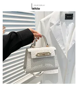 Detail of white handbag featuring premium woven texture and elegant gold lock closure