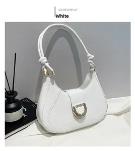 Detail of white PU leather underarm bag with gold D-ring buckle and knotted strap