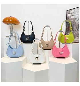 Close-up of hobo shoulder bags in multiple colors with gold D-buckle and knot detail