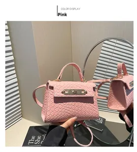 Detailed view of pink woven leather texture and golden twist lock on a stylish handbag