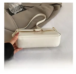 Detailed view of the durable wear-resistant base on the cream baguette shoulder bag