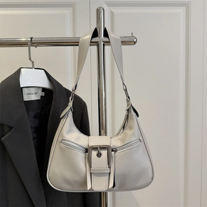 Vintage light gray hobo bag with metal buckle and double zippers on minimalist background