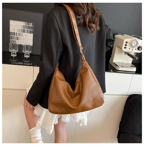Detail of caramel leather tote bag with wide shoulder strap for daily commute