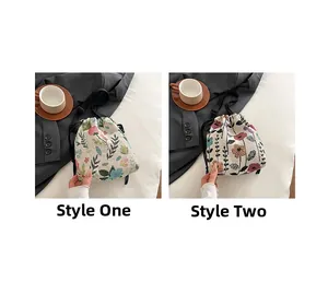 Detail view of two vintage floral jacquard bucket bags with drawstring and black straps