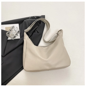 Detail view of large beige hobo bag with soft leather texture and adjustable silver buckle