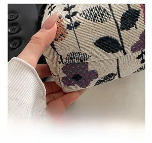 Close-up of floral jacquard fabric and precision stitching on a large shoulder bag