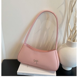 Pink faux leather shoulder bag with silver bow accent and minimalist vintage design