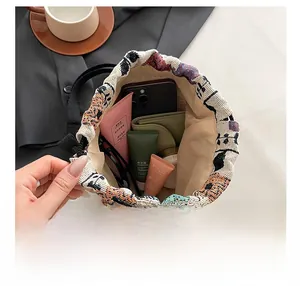 Top view of large capacity bucket bag showing phone and wallet inside a drawstring pouch