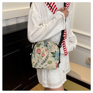 Close-up of vintage floral jacquard bucket bag with adjustable wide shoulder strap
