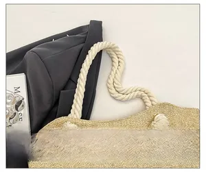 Detail of woven straw tote bag with thick cotton rope handle and decorative tassel knot
