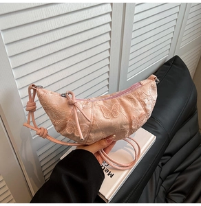 Detailed close-up of pink crescent dumpling bag with delicate butterfly embroidery lace