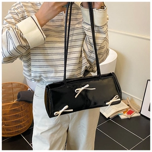 Black patent leather rectangular underarm bag with three decorative white bows