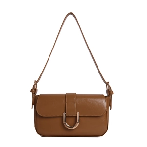 Retro caramel brown glossy leather baguette bag with a large golden metal buckle