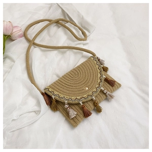 Close-up of bohemian woven crossbody bag with colorful tassels and ethnic embroidery