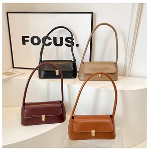 Detailed stack of vintage baguette bags in black, grey, burgundy, and caramel colors