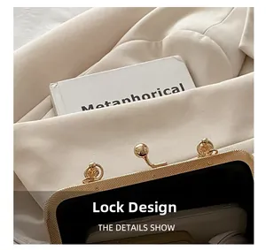 Detail of vintage gold ball clasp on a textured shell bag with elegant retro styling