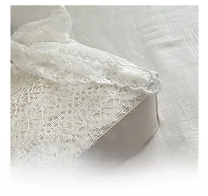 Detailed macro view showing precise stitching on white lace and leather vacation beach bag