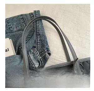 Detail of comfortable shoulder straps and tassel on a grey quilted tote bag