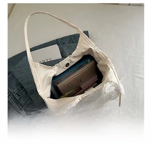 Spacious white lace tote bag interior showing capacity for tablets and books