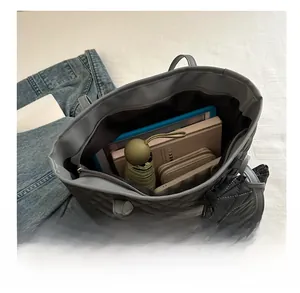 Interior view of grey quilted tote bag showing large capacity with tablet and daily items