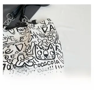 Close-up of graffiti canvas tote bag showing thick fabric texture and metallic ring detail