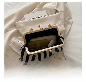 Internal view of the striped handbag showing space for phone and makeup accessories