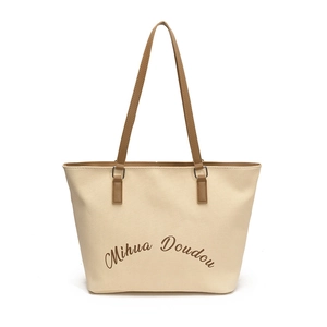 Large beige canvas tote bag with brown leather straps and letter print for women