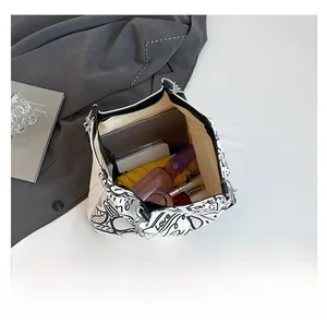 Top-down view of a graffiti tote bag showing large capacity for laptop and essentials