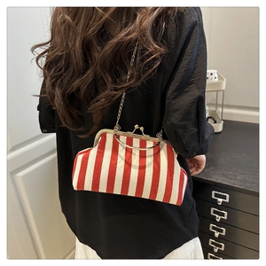 Detail of red and white striped vintage doctor bag with gold chain and metal clasp