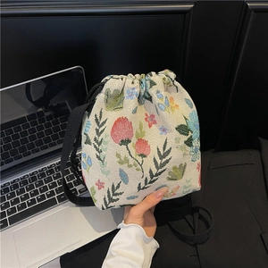 Ethnic style mini drawstring bucket bag with floral embroidery and textile shoulder strap