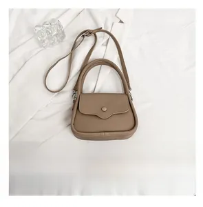 Detail view of brown lychee grain saddle bag with adjustable strap and phone for size