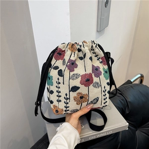 Floral jacquard drawstring bucket bag with black woven straps for summer casual style