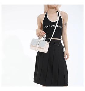 Close-up of pink crossbody bag featuring glitter flap and elegant silver ring handle