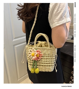 Detailed view of handmade woven flower bucket bag with drawstring liner and long shoulder strap