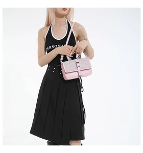 Detail of pink glitter flap handbag with silver metal buckle on a shoulder strap