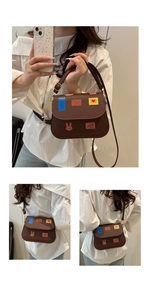 Detail of a brown crossbody bag featuring vibrant creative patches and heart patterns