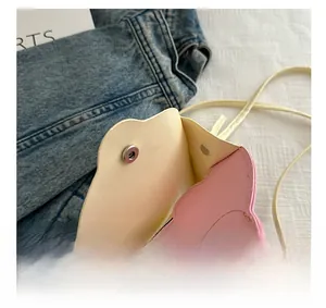 Detail of cloud-shaped crossbody bag featuring pink PU leather and metal magnetic buckle
