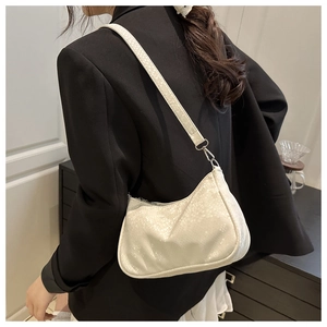 Detail of white moon-shaped shoulder bag with luxury snake pattern and silver zipper