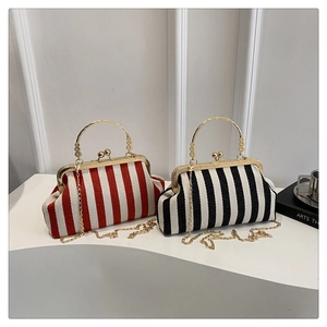 Detail of red and black striped vintage handbags with gold metal handles and kiss-lock closure