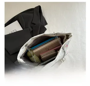 Interior view showing the large capacity of the white floral tote bag with items