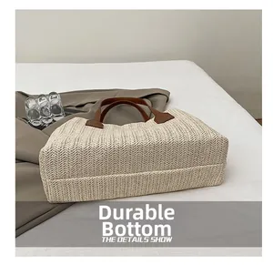 Detailed view of the wear-resistant bottom of this casual straw woven basket bag.