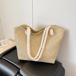 Large woven straw tote bag with white cotton rope handles for summer beach vacations