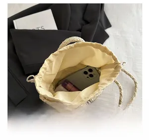 Internal view of handmade straw bucket bag showing large capacity with fabric drawstring liner