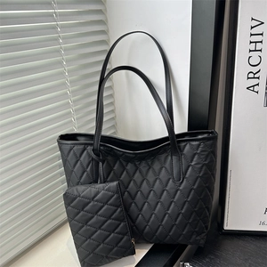 Black quilted tote bag with large capacity and small matching pouch for daily commute