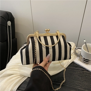 Chic black and white striped shell handbag with gold chain strap and metal handle