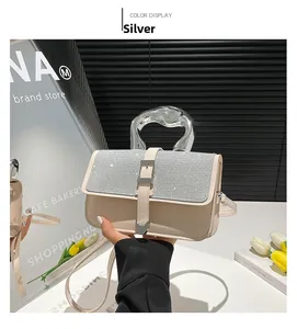 Detail of silver sequin flap and unique liquid metal handle on white crossbody bag