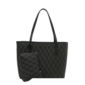 Black quilted tote bag with white contrast stitching and a matching small pouch set
