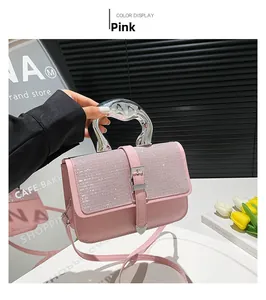 Detail of pink PU leather handbag with rhinestone flap and silver metal handle